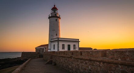 Coastal scene captures a lighthouse at sunset, with a brick wall and a calm sea