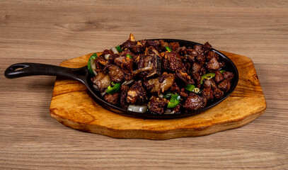 A sizzling hot pan of cha cha tibs an Ethiopian African meat dish