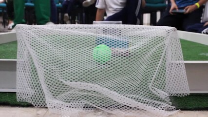 Small robots playing soccer with a ball on a field during a technology and artificial intelligence event at a convention center in Neiva, Huila, Colombia. Concept of technology and innovation  - Powered by Adobe