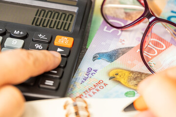 New Zealand money. Financial settlements in New Zealand, financial analysis, tax calculation, risk costs, business project. New Zealand dollars. close up