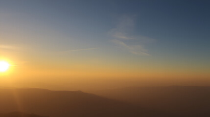 Sunrise over the horizon, radiating warmth and light