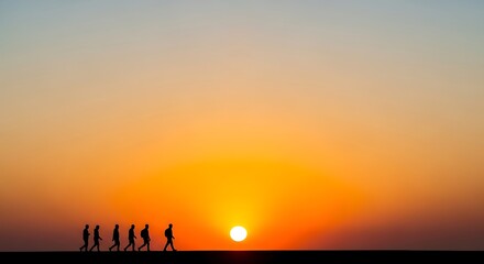 Silhouetted figures walking towards the setting sun, a scenic landscape.
