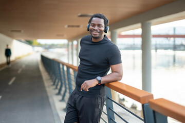 Happy black man enjoying music after workout