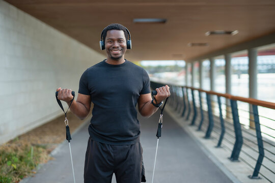 African american man training with resistance bands outdoors
