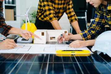 Creative architect projecting on the big drawings with architectural project at construction site at desk in modern office