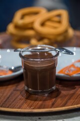 Enjoying rich chocolate drinks with sweet churros in a cozy cafe setting during an afternoon gathering