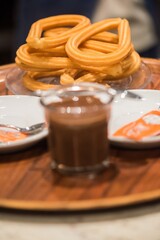 Enjoying rich chocolate drinks with sweet churros in a cozy cafe setting during an afternoon gathering
