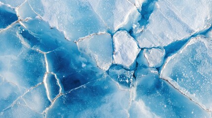 Aerial view of cracked ice formations.  Fractured blue & white surface, intricate patterns