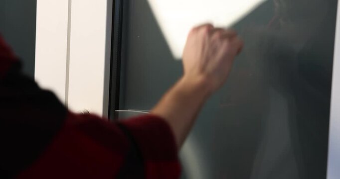 Man knocking on apartment door, closeup view