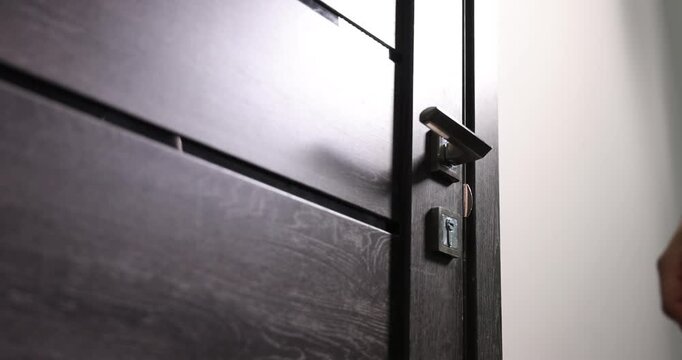 Man knocking on apartment door, low angle view