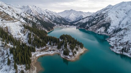 Breathtaking view of the lake in Tianshan Mountain near Kanas Lake, surrounded by snow-capped peaks and pine forests. The turquoise waters reflect the stunning natural landscape.