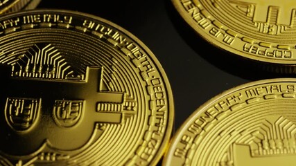 Close up panning view of golden Bitcoin cryptocurrency coins showing details representing digital finance blockchain technology and modern global economic investment concepts - Powered by Adobe
