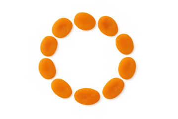 Dried apricots arranged in a circular frame. Healthy sweet snack fruit on isolated background, top down view