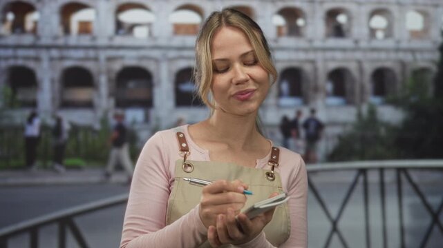 Woman wearing an apron writing in notebook with pen on street in rome while glancing at surroundings; travel exploration memory.