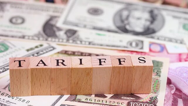 TARIFFSの文字と紙幣（米ドル、日本円、人民元）　回転