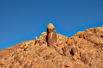 Tall Sandstone Spire with Layered Red Cliffs