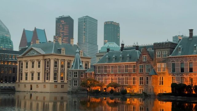 Dutch Parliament in The Hague, Netherlands, illuminated at blue hour. Smooth panorama reflecting perfectly in the Hofvijver pond.

