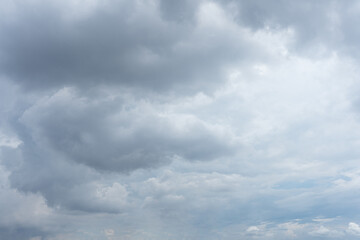 Overcast sky filled with thick grey and white cumulonimbus clouds on a gloomy day