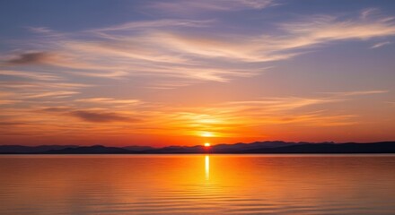 Naklejka premium Panoramic Sunset Over Water with Mountain Silhouette. Vibrant Sunset Sky Reflecting on Calm Lake. Tranquil Landscape with Colorful Horizon.