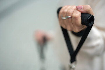 Woman's hand holding fitness resistance band handle