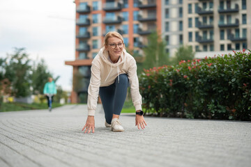 Woman preparing for run, starting sprint race outdoors