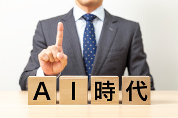 「AI時代 」と書かれたブロックとビジネスマン
