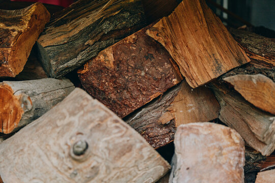 Firewood wood logs stacked wood split logs fireplace rustic pile of seasoned oak near rural cabin, autumn scene, middle-aged bearded homeowner prepping winter fuel and cozy stove. - Powered by Adobe