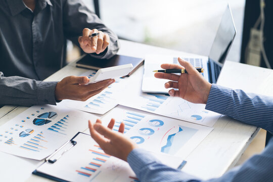 Business Team Analyzing Financial Reports and Data Charts in Meeting