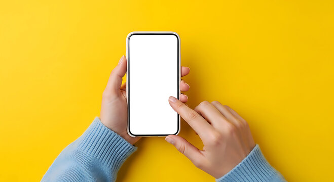 Hands holding blank screen smartphone on bright yellow background mobile