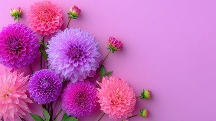 Bright multicolored flowers arranged in a clear vase sitting on a smooth pink surface, with soft natural lighting and a clean minimalist background.