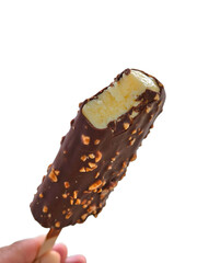 Bite taken from a chocolate and almond-coated ice cream bar showing creamy vanilla inside.