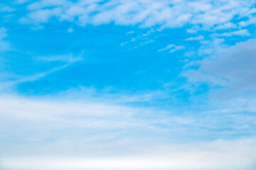 Fototapeta premium A bright, clear blue sky meets a glowing white horizon, suggesting a serene, open, and with sunlight of beautiful cloudy sky. landscape or abstract background. 