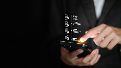 Business professional using smartphone with virtual checklist task management app