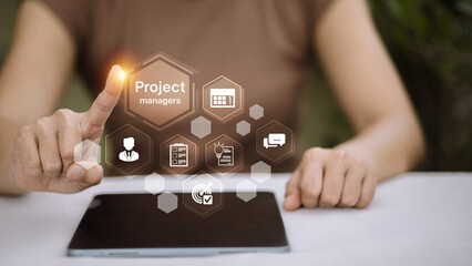 Female project manager using digital tablet with virtual project management icons
