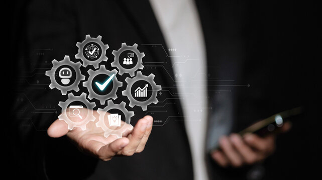 Businessman holding virtual gears with AI automation and business process optimization icons
