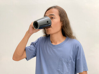 long haired man drinking