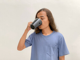 long haired man drinking