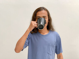 long haired man drinking