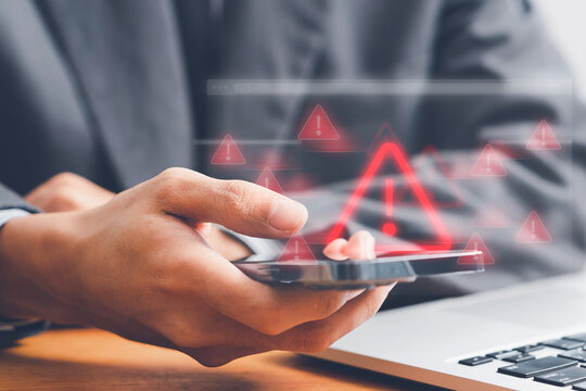 System warning alert on a virtual interface with hand interaction, illustrating cybersecurity risks, data breaches, malware threats, hacking, and digital system vulnerabilities.