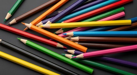 A Vibrant Assortment of Sharpened Colored Pencils Scattered on a Dark Surface.