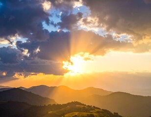 Golden sunset rays bursting through dramatic, cloud-filled sky over mountains