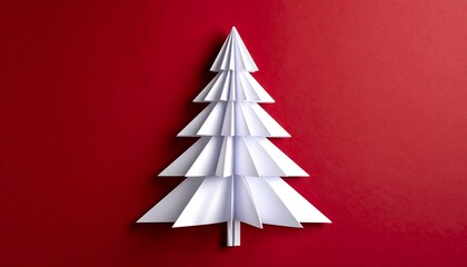 A crafted paper Christmas tree of folded white sections on a rich red background