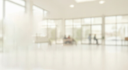 People in a modern office with glass walls.