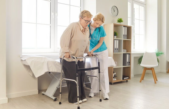 Medical professional assists elderly woman using walker in modern clinic, nurse provides physical and emotional support during rehabilitation. Elder care, mobility challenges, physical therapy concept