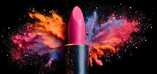 Vibrant pink lipstick explodes with colorful powder against a dark background
