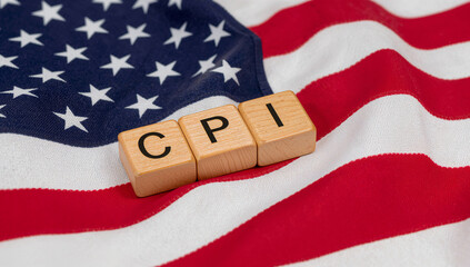 Wooden CPI blocks on the United States flag symbolizing American inflation data, economy trends, and price index.
