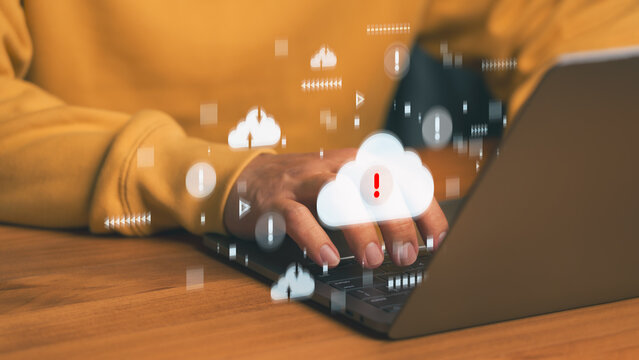 Cloud computing data protection concept with warning symbol on a laptop computer, representing cybersecurity threats, data loss prevention, and secure cloud storage in digital technology environment.