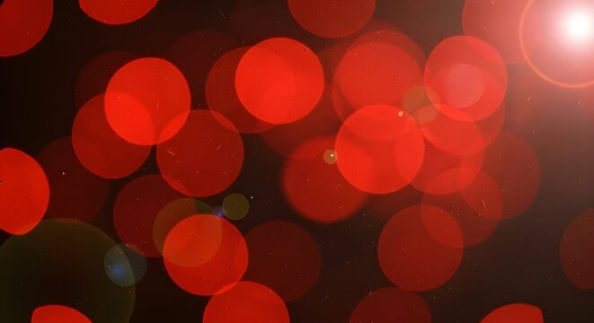 Abstract Red Bokeh Lights with Lens Flare on Dark Background.