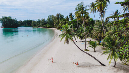 Relaxing day on the beautiful beaches of Koh Kood Island Thailand with palm trees and calm waters