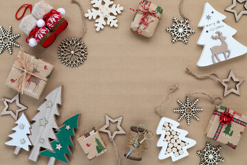 Festive holiday ornaments in a border frame on brown paper.